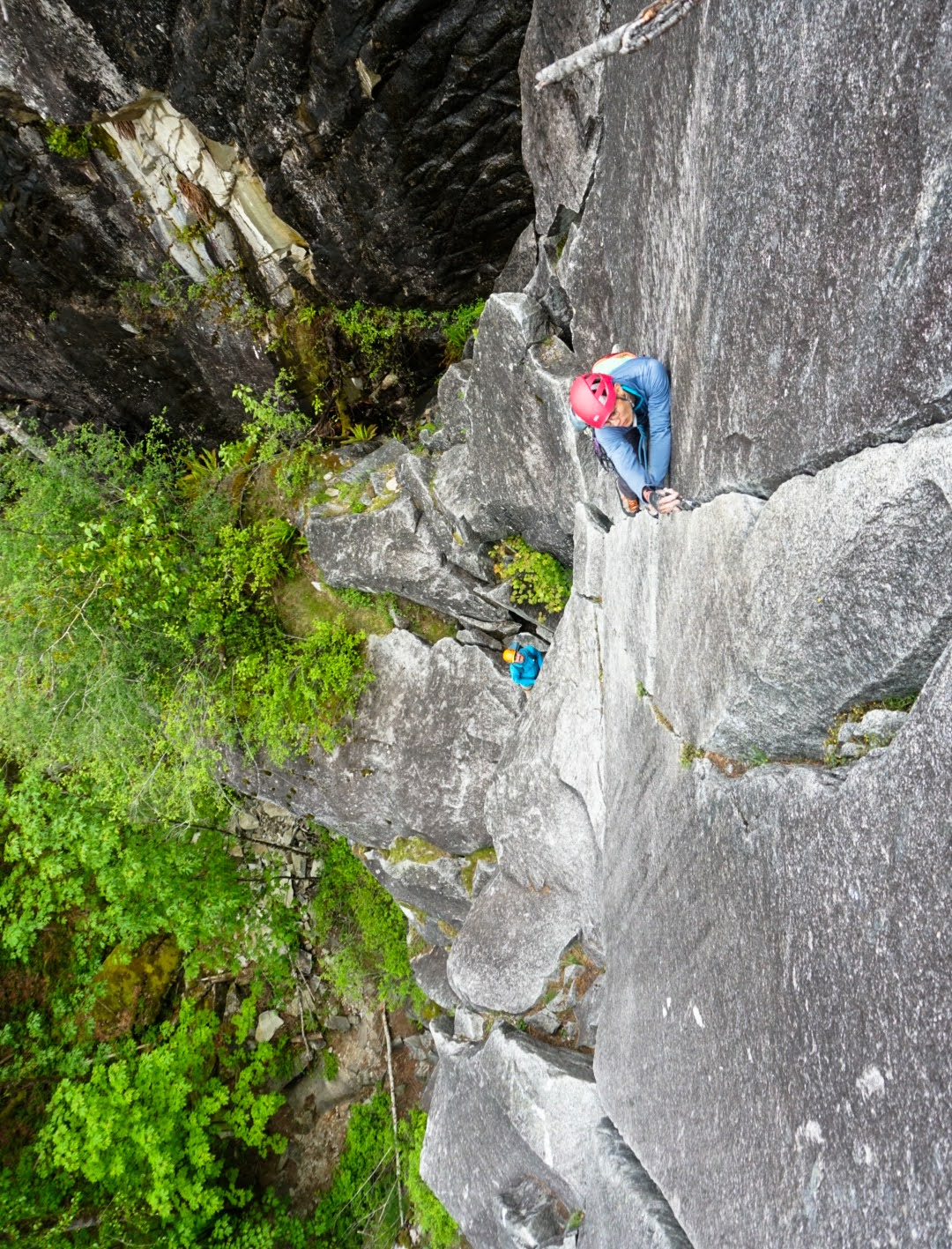 Placing a cam for protection on pitch 2 (5.6) of Pisces at the Index Town Wall (pc: Lani)